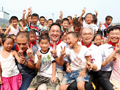 Mr Chen (centre) attends the school year-opening ceremony of Jinshan Town No. 1 Primary School in Deyangshi, Sichuan.