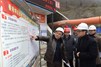 Mr Chan (right) visits the construction site on the section of Provincial Road 303 from Yingxiu to Wolong, a project funded by the HKSaR, and receives a briefing from a site officer.