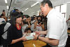 The Chief Secretary for Administration, Mr Henry Tang, presents a souvenir to a student representative of the Shuimo Middle School.