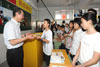 Student of Baita Secondary School presents souvenir to the Chief Secretary for Administration, Mr Henry Tang.