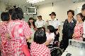 Miss Yang Liu (on wheelchair), Miss Chen Juan (in white skirt) and Miss Wang Li (first from right) visited the Lai King Correctional Institution and shared their experiences in facing calamity with young female inmates. 