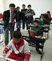 Mr Young visits a music class at De Yang City Youth and Children's Palace.